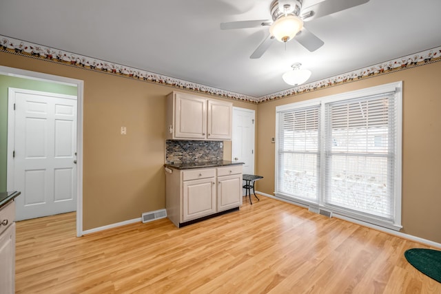 kitchen featuring decorative backsplash, light hardwood / wood-style flooring, and ceiling fan