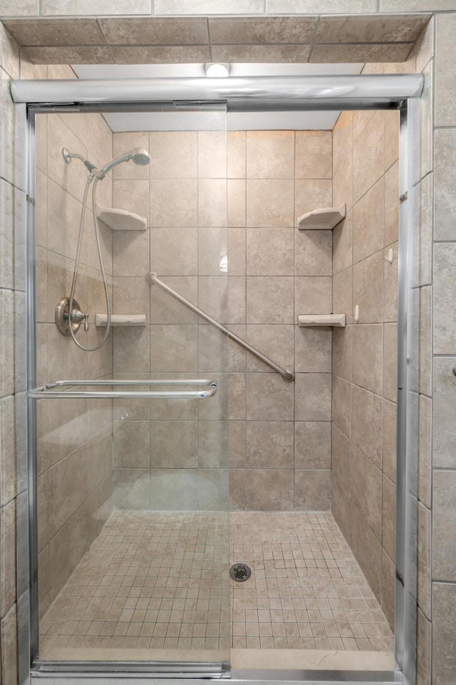 bathroom with a shower with shower door