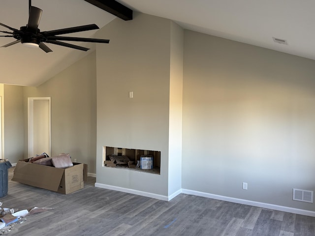 unfurnished living room featuring hardwood / wood-style floors, vaulted ceiling with beams, and ceiling fan