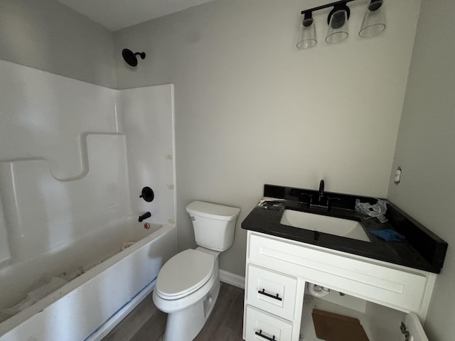 full bathroom featuring vanity, hardwood / wood-style flooring, toilet, and shower / washtub combination