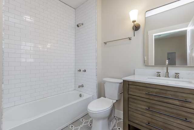 full bathroom with tiled shower / bath, tile patterned flooring, vanity, and toilet