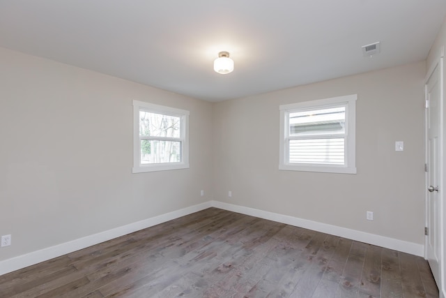 unfurnished room featuring hardwood / wood-style flooring and a healthy amount of sunlight