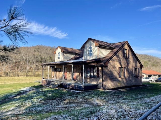 view of property exterior with a yard and covered porch