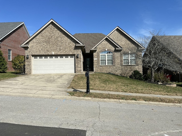 view of front of property with a front yard and a garage