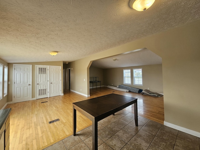 rec room featuring a textured ceiling and hardwood / wood-style flooring