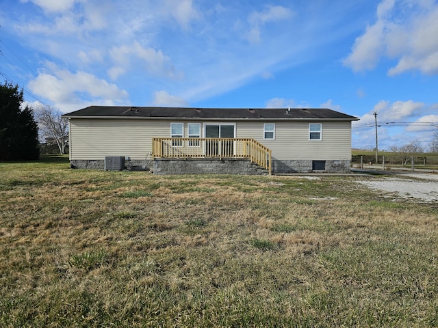 back of property featuring a yard, a wooden deck, and central AC