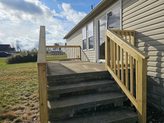 wooden deck with a lawn