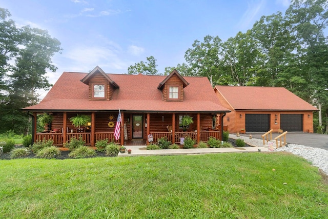 log home featuring covered porch, a garage, and a front lawn