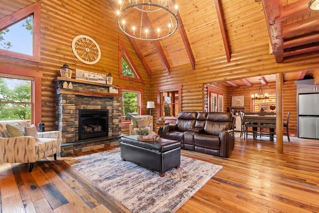 living room with log walls, beam ceiling, an inviting chandelier, high vaulted ceiling, and light hardwood / wood-style flooring