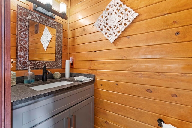 bathroom with vanity and wooden walls