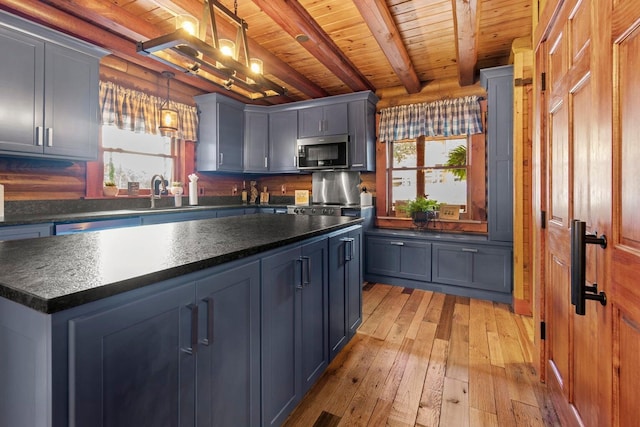 kitchen with wooden ceiling, light wood-type flooring, beamed ceiling, decorative light fixtures, and a kitchen island