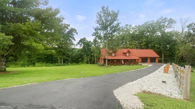 view of front of property with a front lawn and a garage