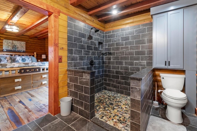 bathroom featuring wooden ceiling, hardwood / wood-style flooring, toilet, tiled shower, and beamed ceiling