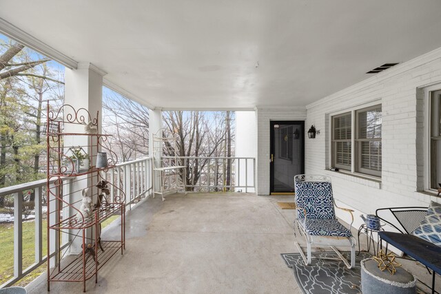 exercise area with plenty of natural light, ceiling fan, and ornamental molding