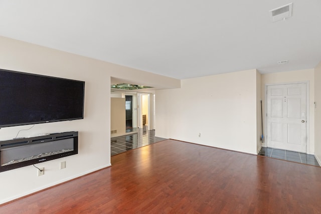 unfurnished living room featuring dark hardwood / wood-style flooring