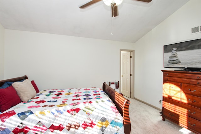 carpeted bedroom with ceiling fan and vaulted ceiling