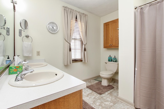 bathroom featuring tile patterned floors, vanity, toilet, and walk in shower