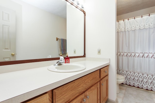 bathroom featuring vanity, a shower with shower curtain, and toilet