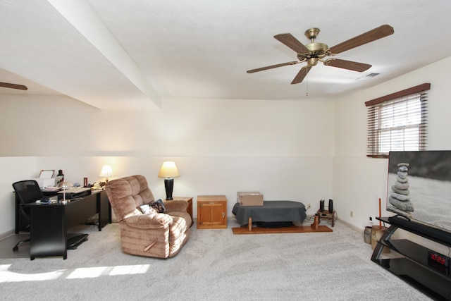 living area featuring light colored carpet and ceiling fan