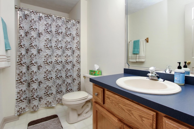 bathroom featuring vanity, curtained shower, and toilet