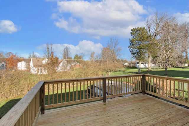 wooden deck featuring a yard