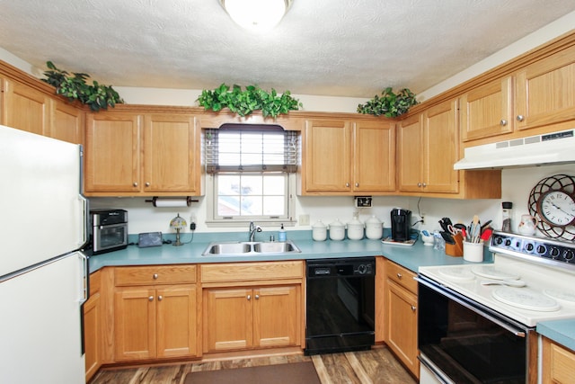 kitchen featuring a textured ceiling, light wood-type flooring, white appliances, and sink