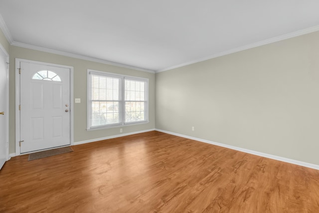 entrance foyer featuring hardwood / wood-style flooring and crown molding