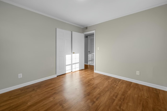 unfurnished bedroom with wood-type flooring and ornamental molding