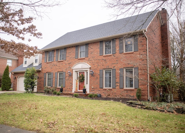 colonial house with a garage and a front yard