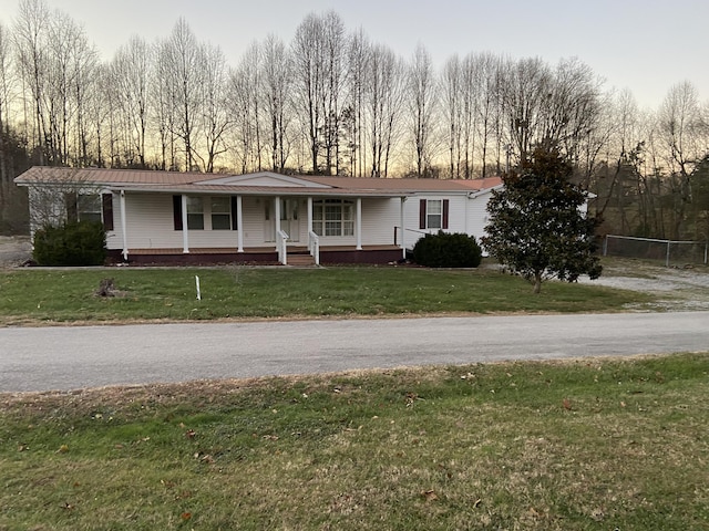 view of front of home with a yard and covered porch