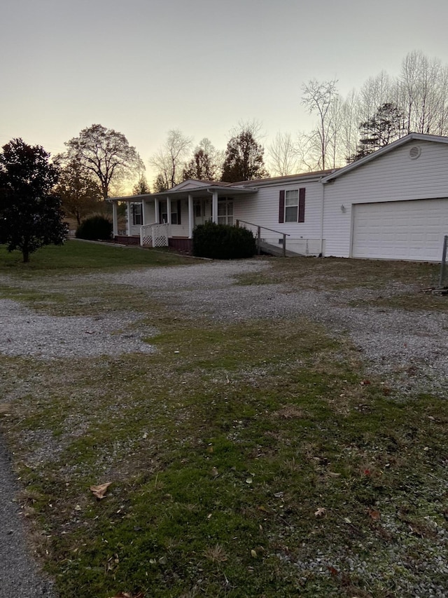 view of front of property featuring a porch and a garage