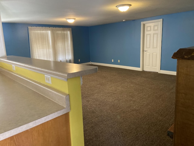 interior space with dark colored carpet