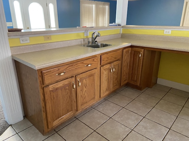 kitchen featuring sink and light tile patterned flooring