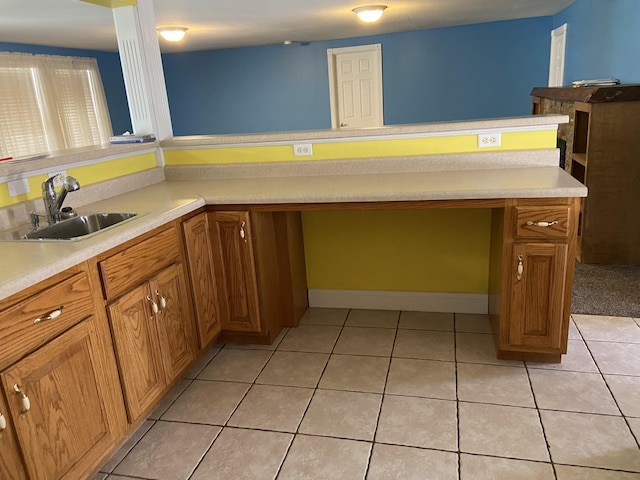 kitchen featuring light tile patterned floors and sink