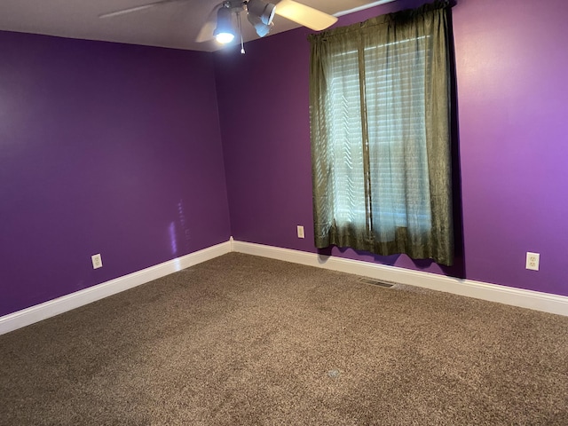 spare room with carpet floors and ceiling fan