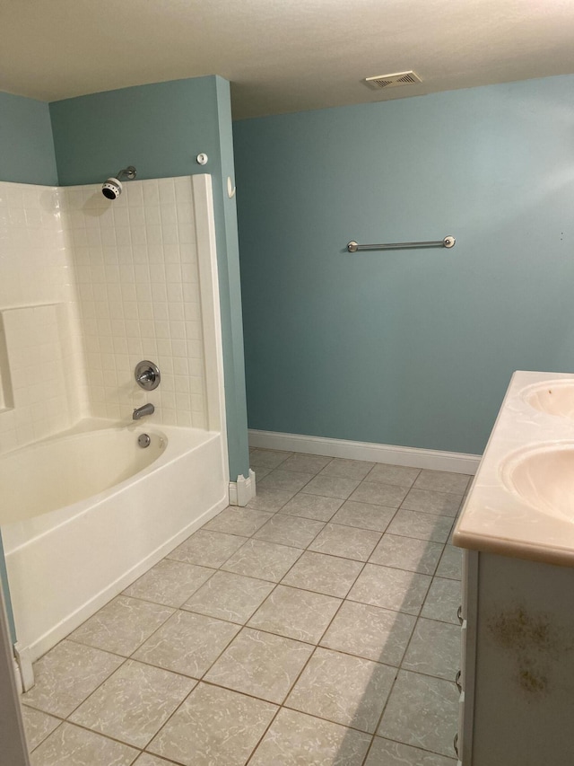 bathroom with tile patterned flooring, vanity, and tiled shower / bath combo