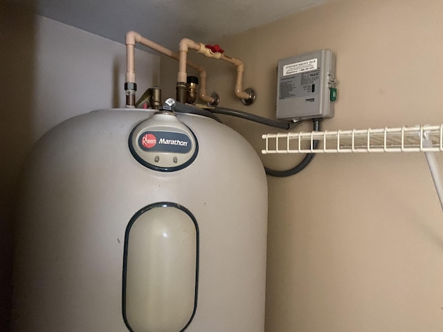 utility room featuring electric water heater