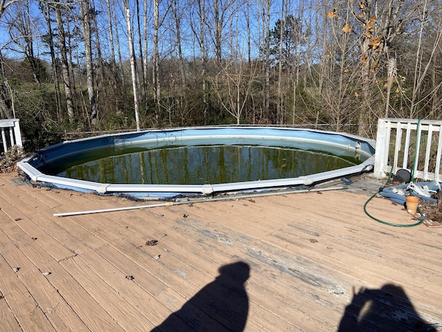 view of swimming pool featuring a deck