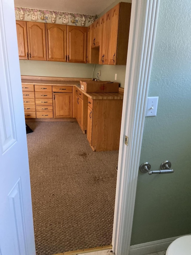 kitchen with light colored carpet