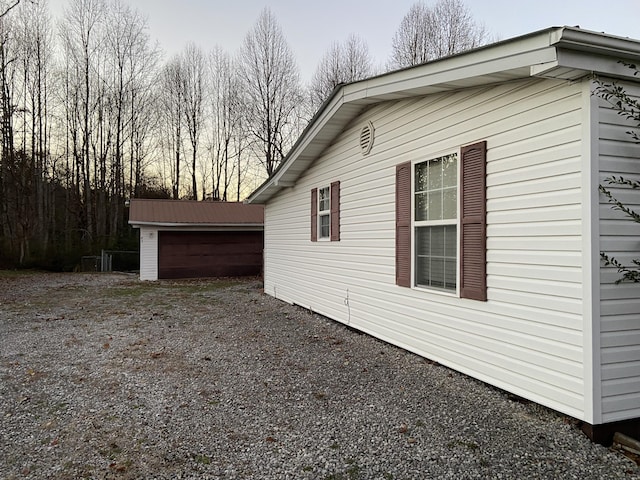 view of home's exterior with an outbuilding and a garage