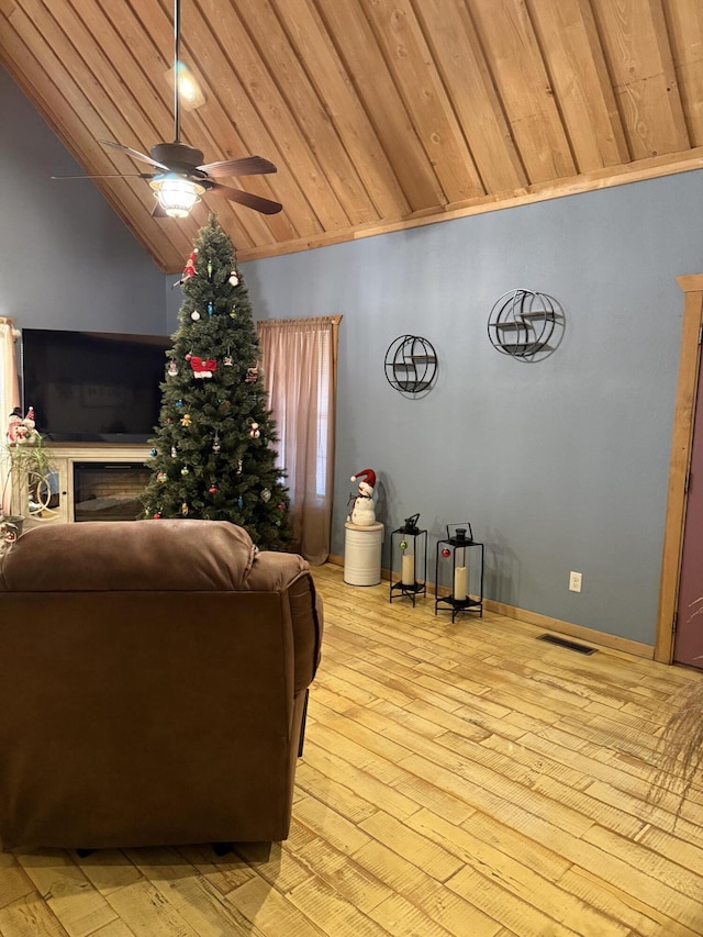 living room featuring ceiling fan, light wood-type flooring, wooden ceiling, and lofted ceiling