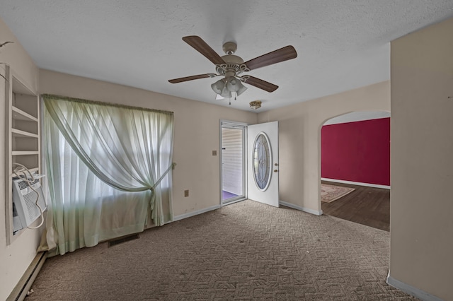 carpeted spare room featuring ceiling fan, a healthy amount of sunlight, and a textured ceiling