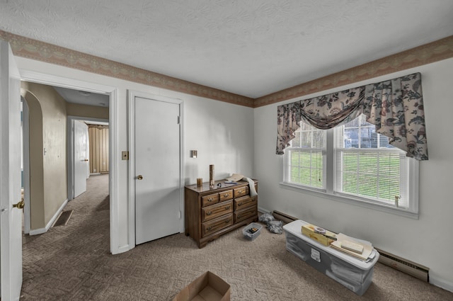 miscellaneous room featuring carpet flooring, a textured ceiling, and baseboard heating