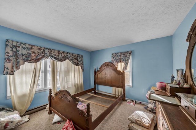 bedroom with baseboard heating, light carpet, and a textured ceiling