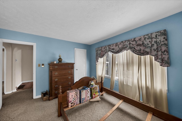 carpeted bedroom with a textured ceiling