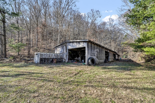 view of outbuilding featuring a lawn