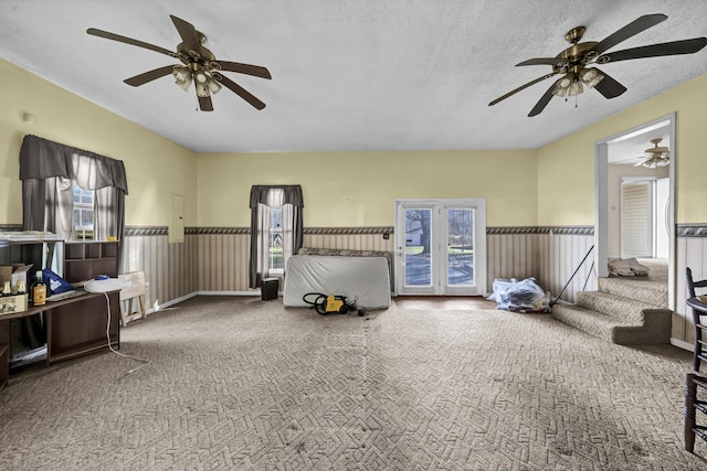 interior space with a textured ceiling, carpet floors, and electric panel