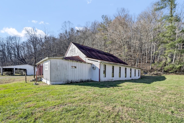 view of home's exterior with a lawn and a carport