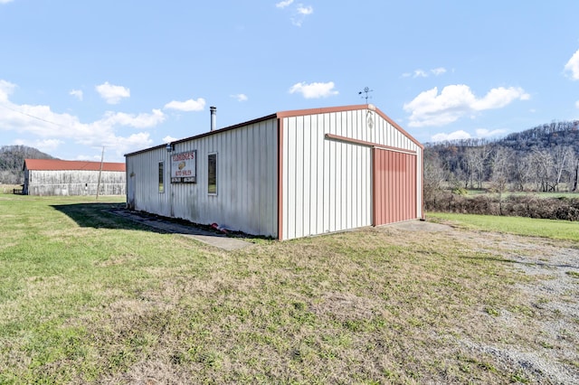 view of outbuilding with a yard