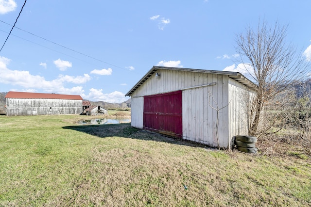 view of outbuilding with a yard